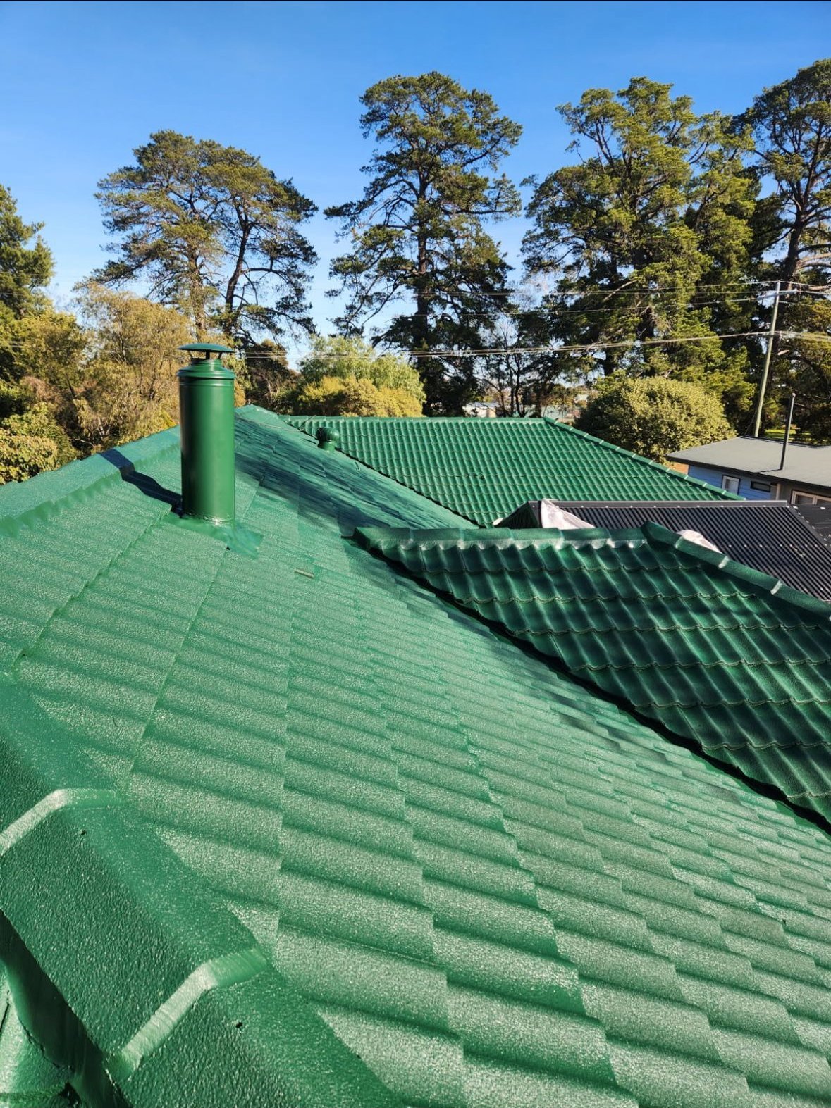 Roof after restoration, freshly painted green roof Melbourne